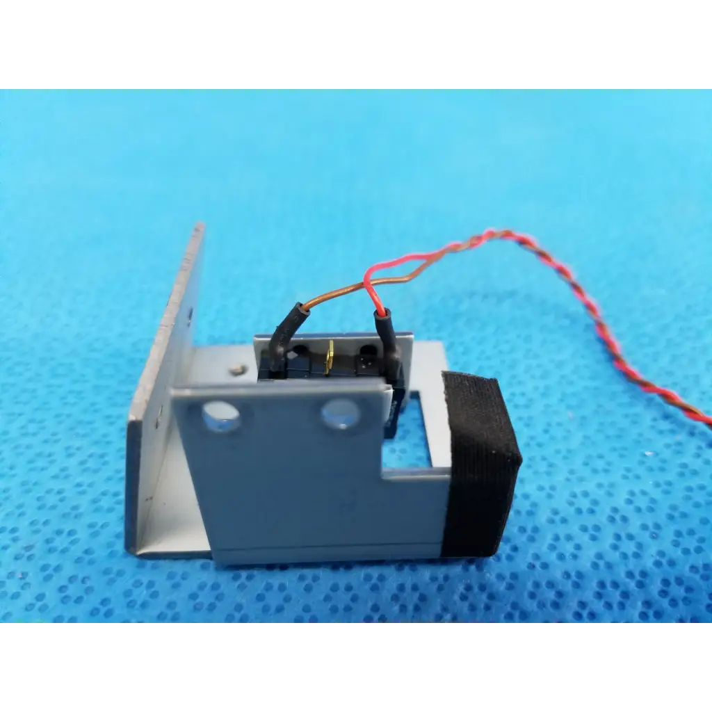 Gray metallic internal mechanical limit position sensor with black rubber panel and red white wiring for Topcon fundus camera