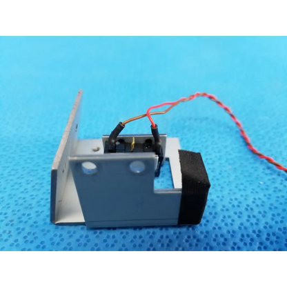 Gray metallic internal mechanical limit position sensor with black rubber panel and red white wiring for Topcon fundus camera