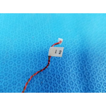 Red and black twisted wire with white connector and label 1 2 for internal mechanical limit sensor in topcon fundus camera