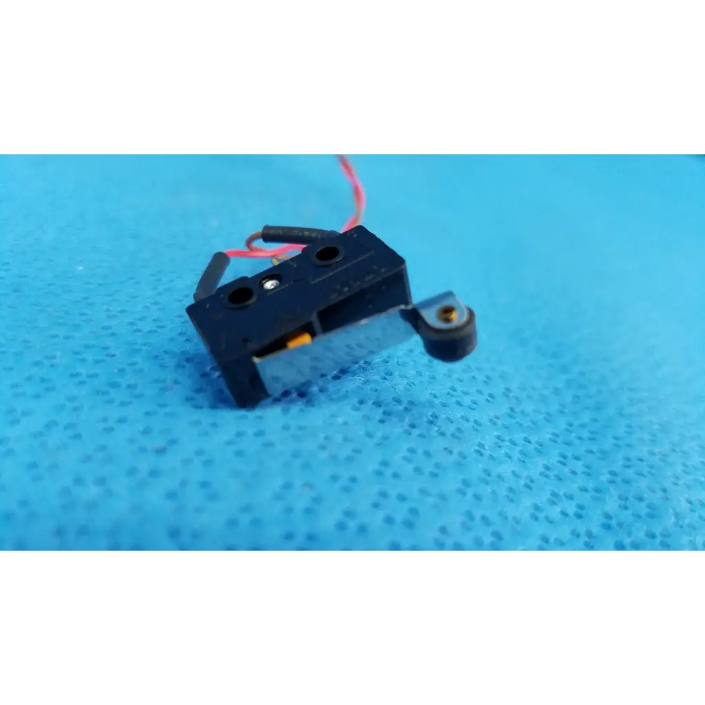 Black plastic internal mechanical subminiature hinge roller lever microswitch with red and black wires and metallic arm