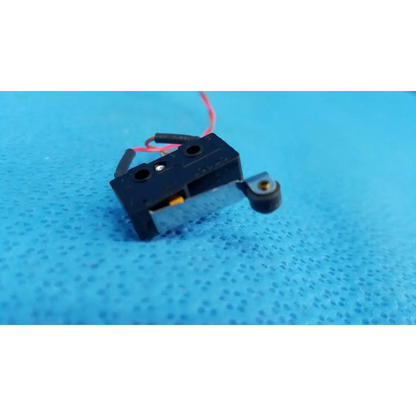 Black plastic internal mechanical subminiature hinge roller lever microswitch with red and black wires and metallic arm