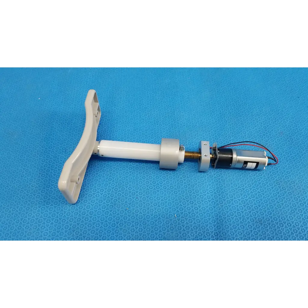 White plastic t-shaped handle attached to a cylindrical shaft with micro gear motor for motorized chinrest assembly