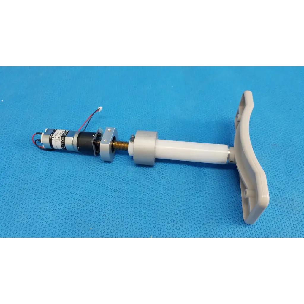 White plastic handle attached to internal motorized chinrest with micro gear motor and wiring for topcon trc-nw8 fundus camera