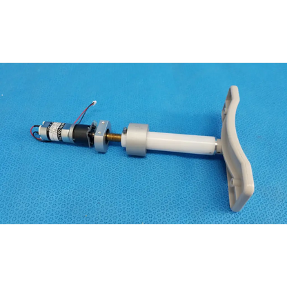 White plastic handle attached to internal motorized chinrest with micro gear motor and wiring for topcon trc-nw8 fundus camera