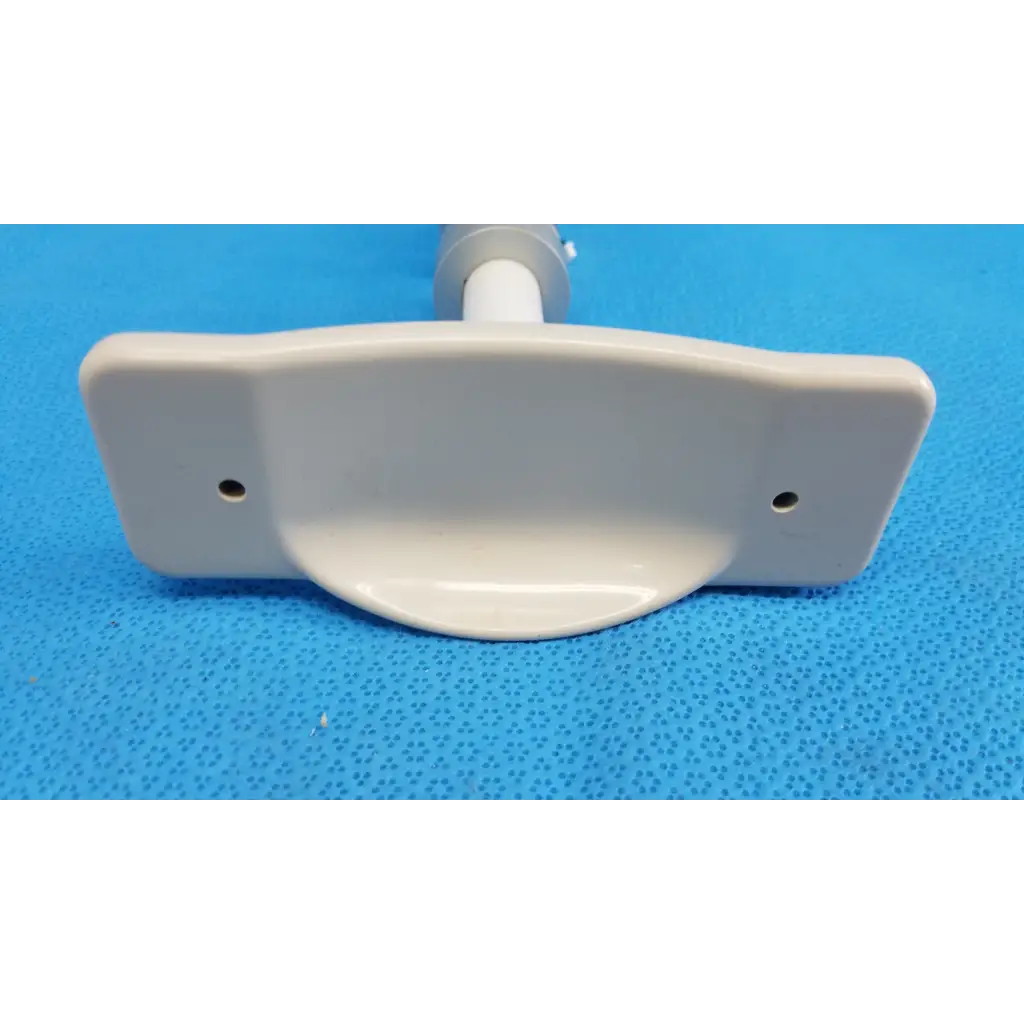 White plastic mounting bracket with two holes for attachment in internal motorized chinrest gear motor assembly for topcon camera