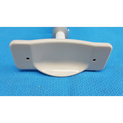 White plastic mounting bracket with two holes for attachment in internal motorized chinrest gear motor assembly for topcon camera