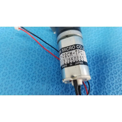 Silver cylindrical micro gear motor with black wiring and en micro label for topcon motorized chinrest assembly
