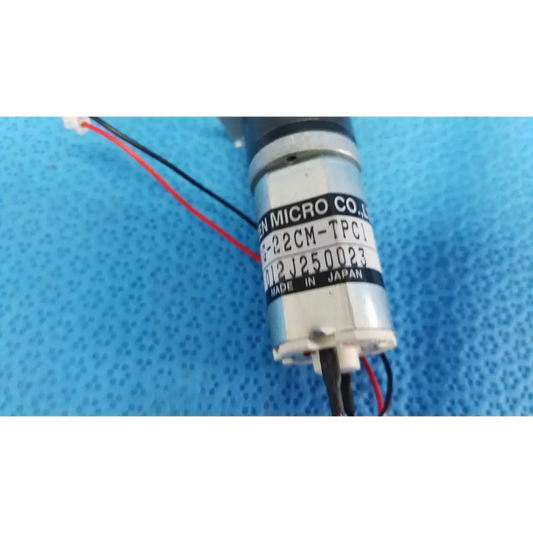 Silver cylindrical micro gear motor with black wiring and en micro label for topcon motorized chinrest assembly