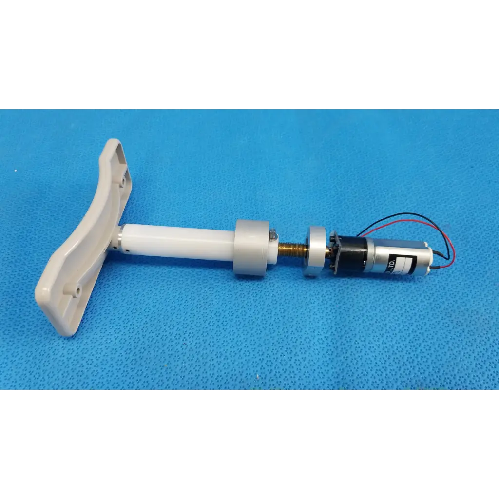 White plastic t-shaped handle attached to a cylindrical internal motorized chinrest micro gear motor assembly with wiring