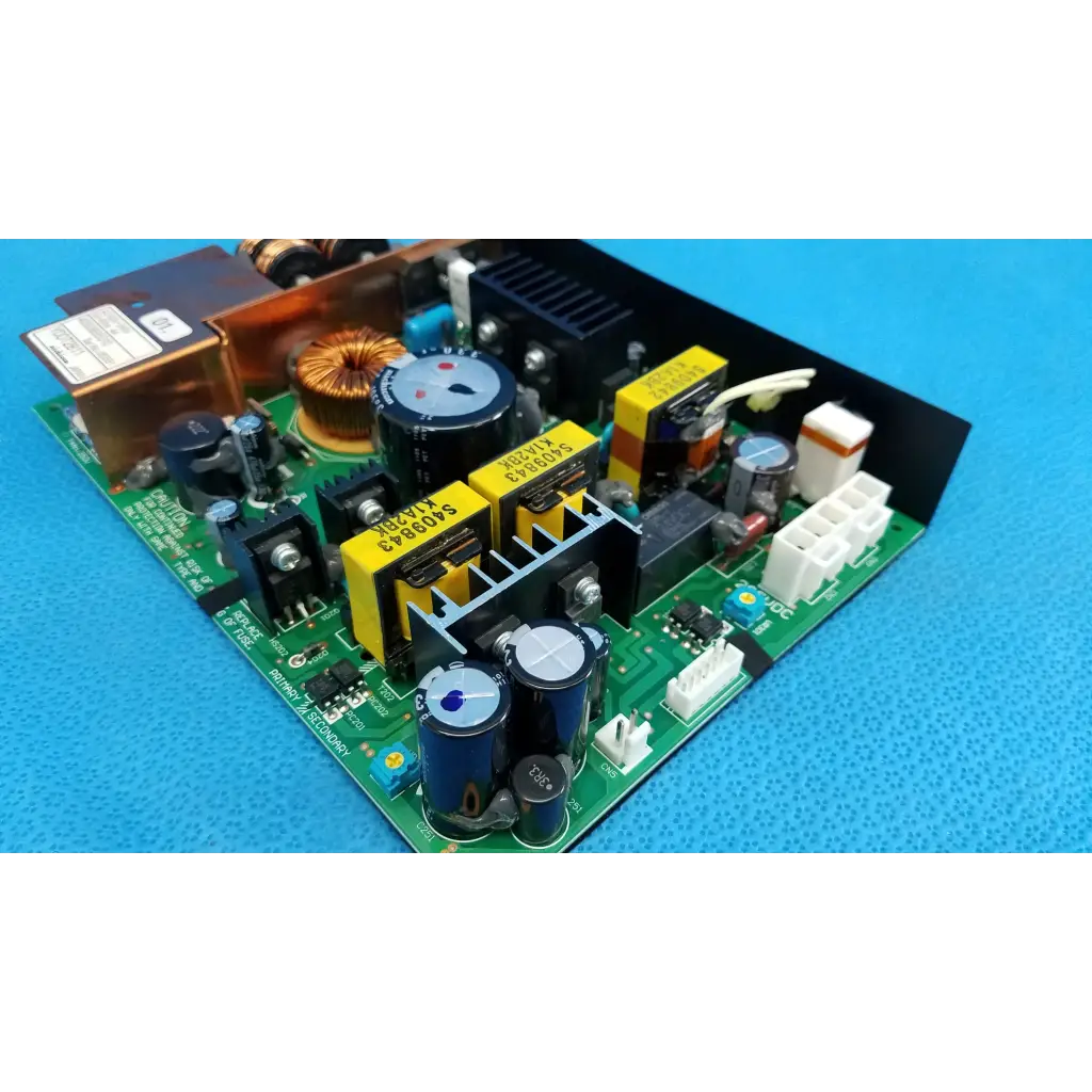 Green printed circuit power supply board with blue capacitors yellow heat sinks and black connectors for topcon fundus camera