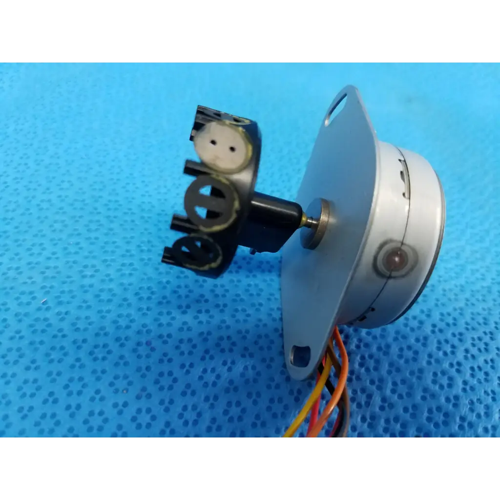 Silver cylindrical internal npm stepper motor with black plastic parts and wiring for Topcon trc-nw8 retinal camera