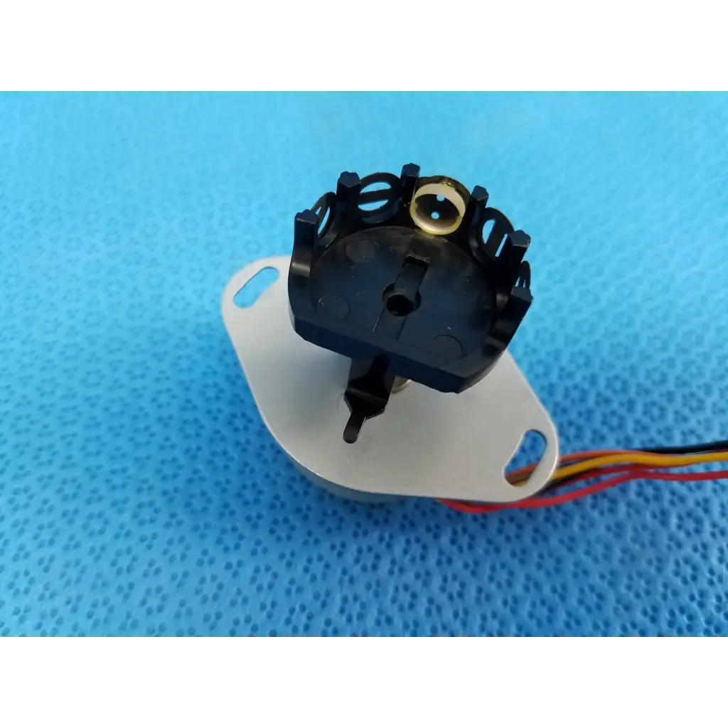 Black plastic rotary switch with gold center and multicolor wires for internal npm stepper motor in trc-nw8 retinal camera