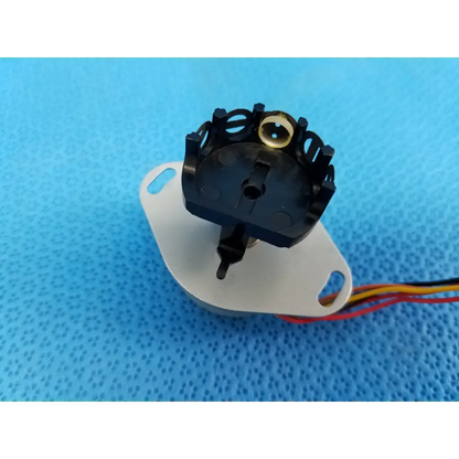 Black plastic rotary switch with gold center and multicolor wires for internal npm stepper motor in trc-nw8 retinal camera