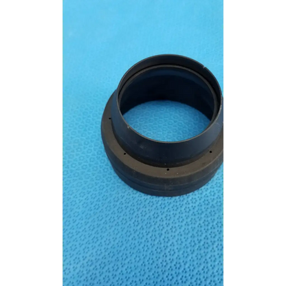 Black rubber dust cap with textured surface and small holes for viewfinder bellows alignment ring in topcon camera set