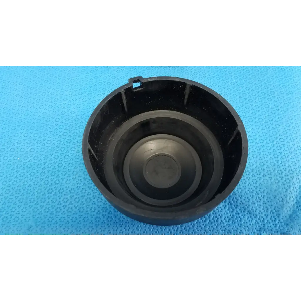 Black plastic dust cap with concentric ridges and a rectangular tab for viewfinder bellows alignment ring set