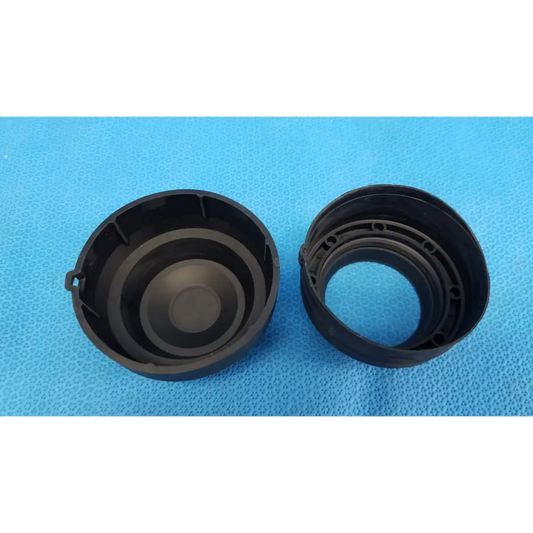 Black plastic objective lens rubber dust cap with circular ridges and molded tabs for Topcon TRC-NW8 retinal camera