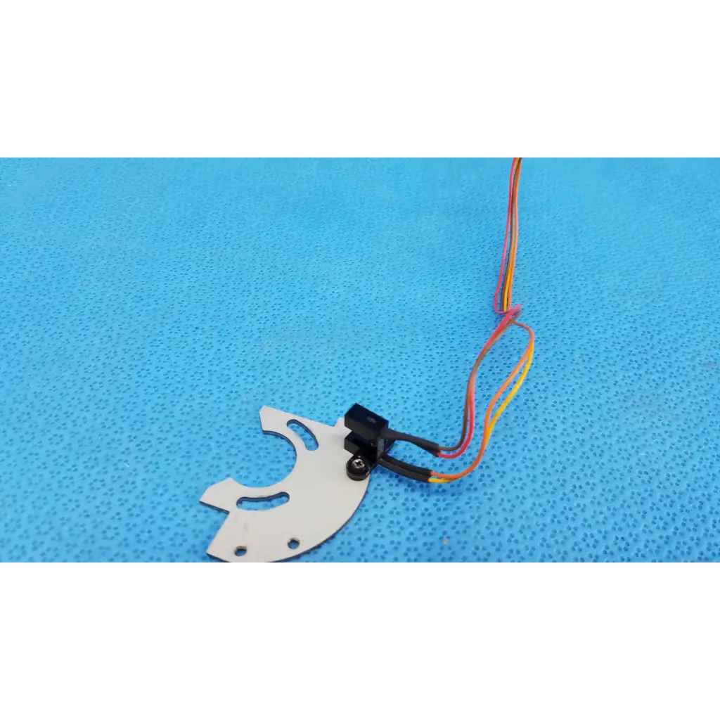 White plastic gear with black sensor and colorful wires mounted on aluminum bracket for optical base axis limit assembly