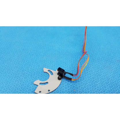 White plastic gear with black sensor and colorful wires mounted on aluminum bracket for optical base axis limit assembly