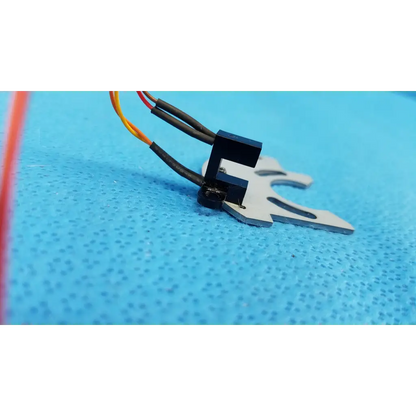 Black and silver optical base axis limit sensor with multi-colored wires and aluminum bracket for topcon fundus camera