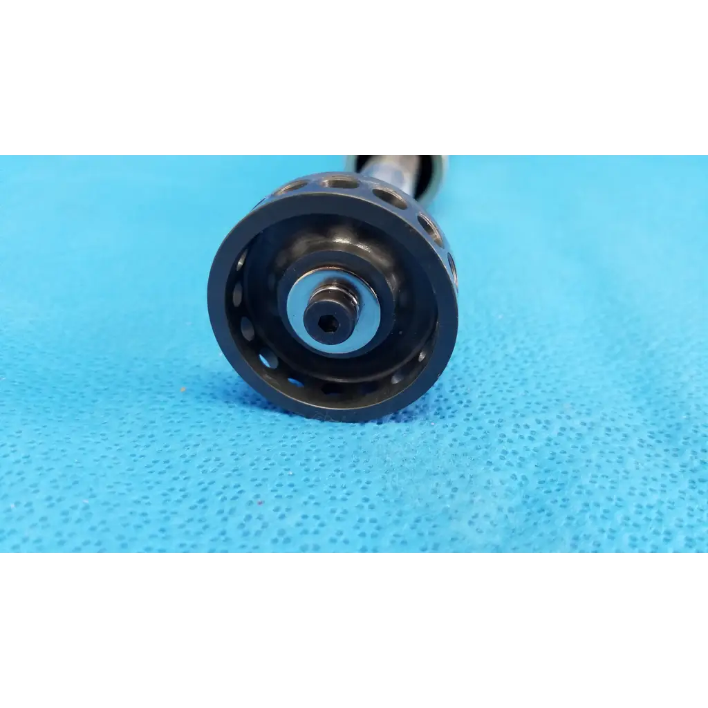 Black perforated metal fishing reel handle with a central metallic shaft for optical core piston cylinder use