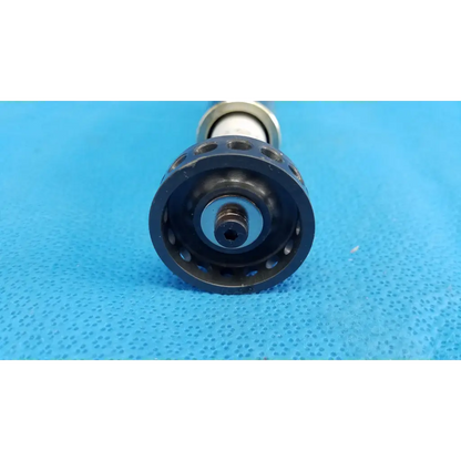Black plastic optical core piston gear with circular cutouts mounted on metallic shaft for topcon trc-nw8 camera