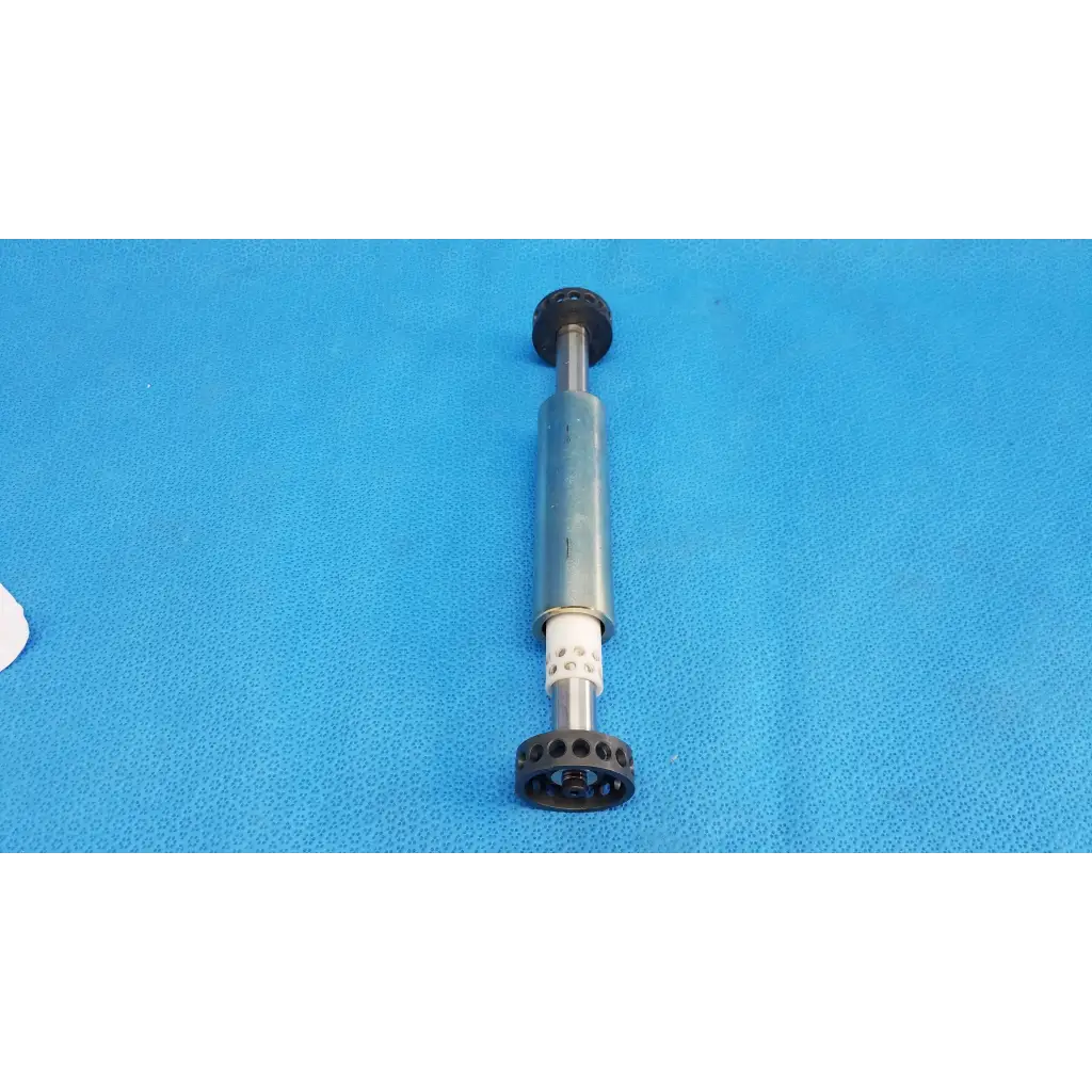 Gray and black manual muscle stimulator with textured grip handle for internal optical core piston cylinder use