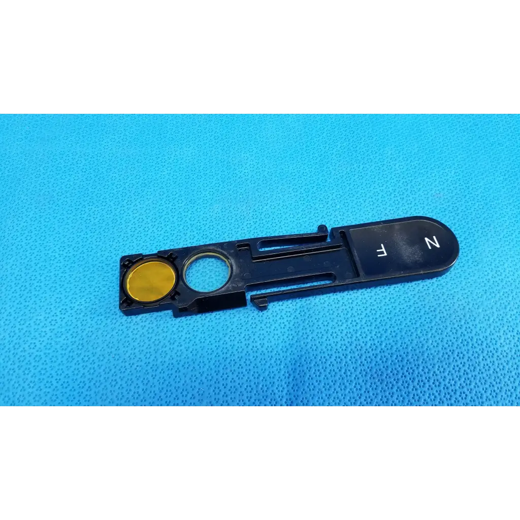 Black plastic optical filter slider key with gold button and white fn lettering for topcon fundus retinal camera