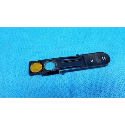 Black plastic optical filter slider key with gold button and white fn lettering for topcon fundus retinal camera