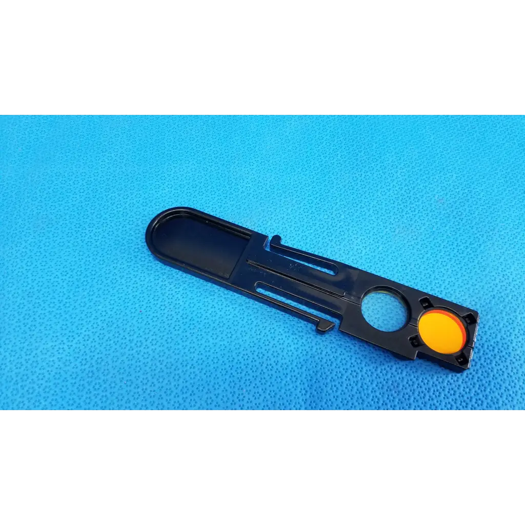 Black plastic optical filter slider with a bright yellow button for fundus retinal camera topcon trc-nw8 internal use