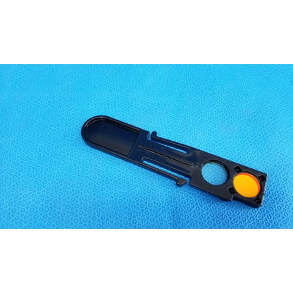 Black plastic optical filter slider with a bright yellow button for fundus retinal camera topcon trc-nw8 internal use
