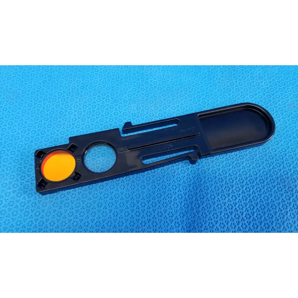 Black plastic internal optical filter slider lens part with bright orange circular insert for topcon fundus retinal camera