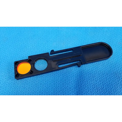 Black plastic internal optical filter slider lens part with bright orange circular insert for topcon fundus retinal camera