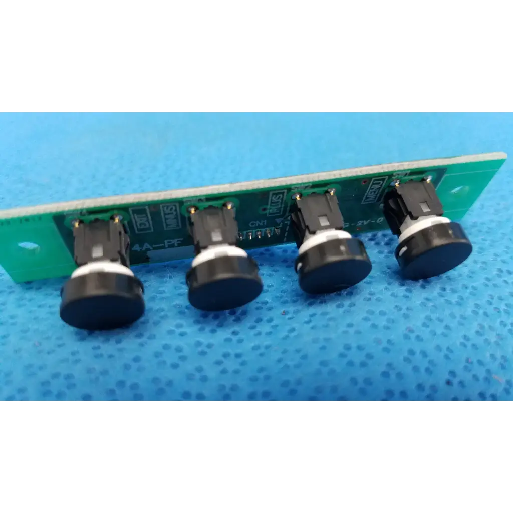 Green circuit board with four black control menu switch buttons on white bases for internal osd control menu pcb board