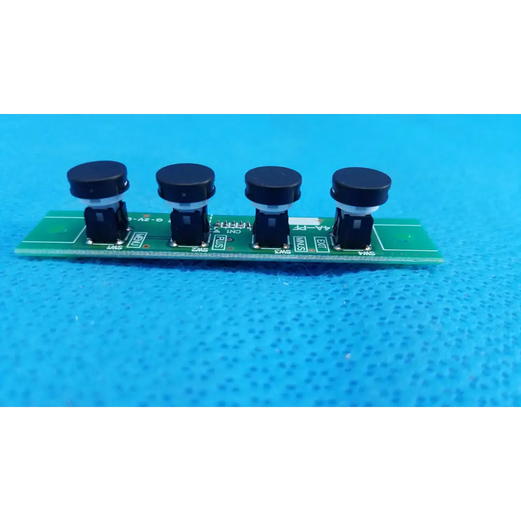 Green PCB board with four black push-button menu switch buttons for OSD control menu on Topcon TRC-NW8 camera