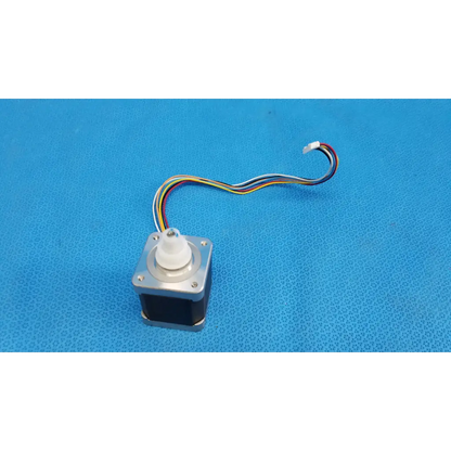Silver metallic stepper motor with white plastic shaft and multicolored wiring for topcon trc-nw8 fundus camera