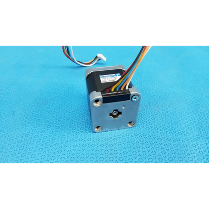 Silver-colored metal stepper motor with black top housing and multicolor wiring for topcon trc-nw8 fundus camera