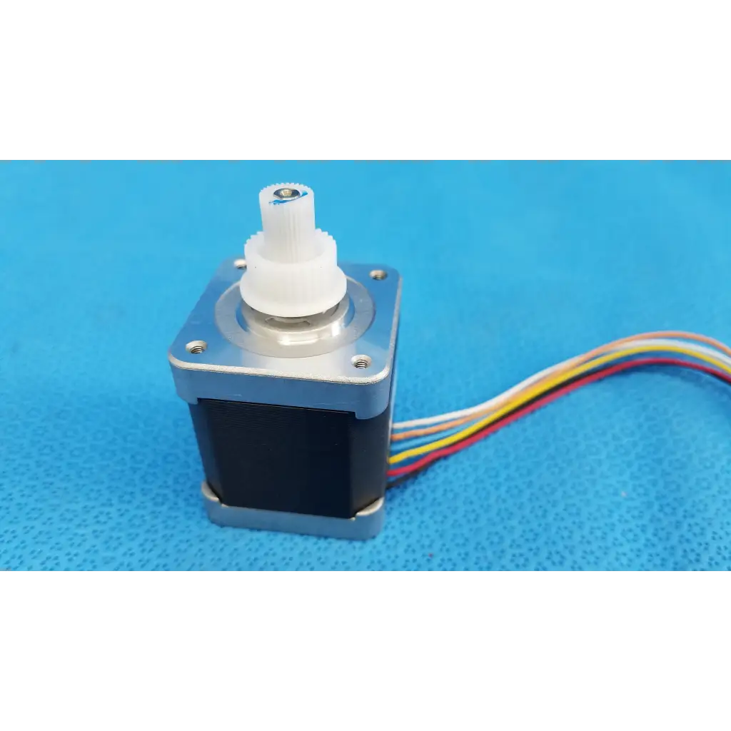 Silver and black internal sanyo denki stepper motor with white gear and multi-colored wiring for topcon trc-nw8 fundus camera