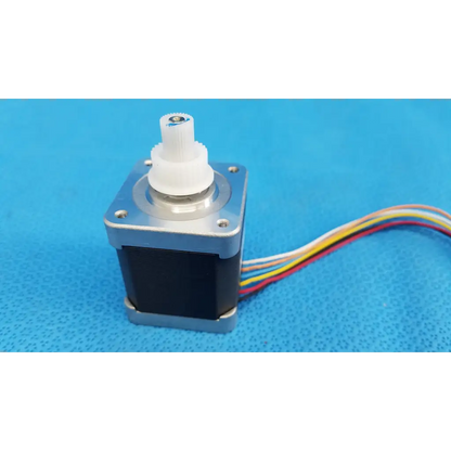 Silver and black internal sanyo denki stepper motor with white gear and multi-colored wiring for topcon trc-nw8 fundus camera