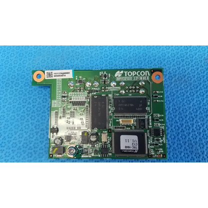 Green Topcon logic motherboard board with black integrated circuits and silver solder points for fundus retinal camera