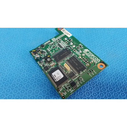 Green topcon logic motherboard board with black integrated circuits and silver solder points for fundus retinal camera