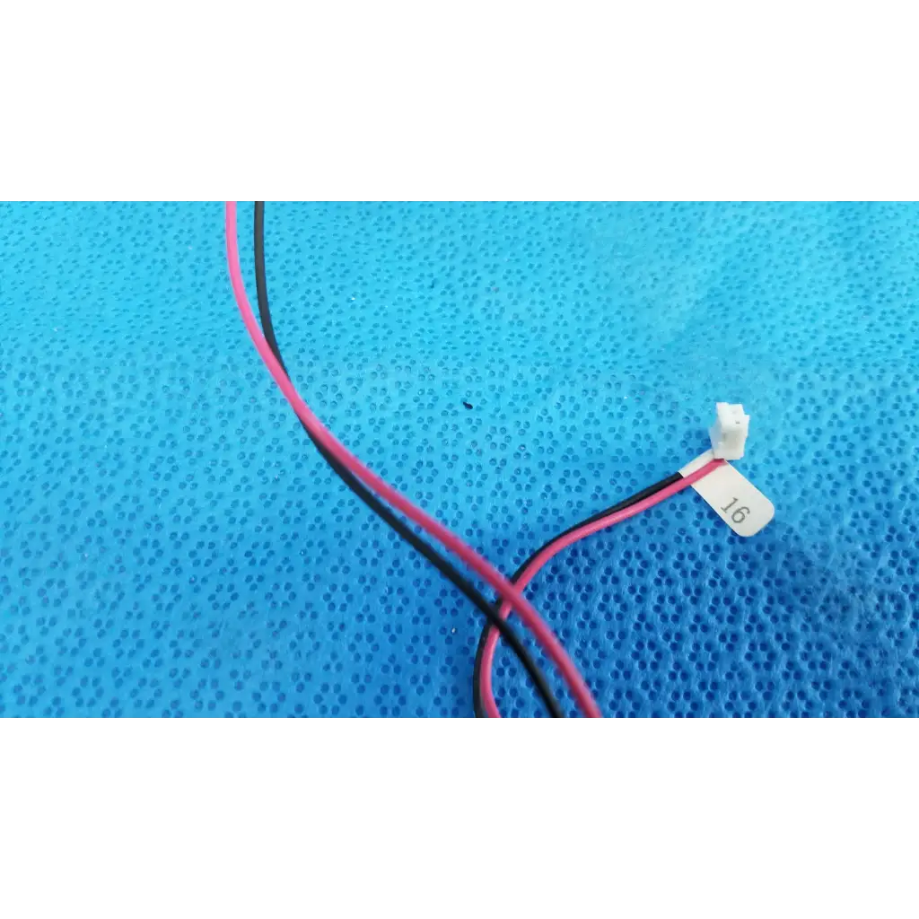 A pair of thin pink and black insulated wires with white connector for rotary solenoid aperture diaphragm sap1-t115b