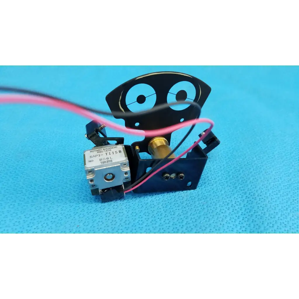 Black robot-shaped internal takano rotary solenoid aperture diaphragm with silver motor and pink wire for topcon camera