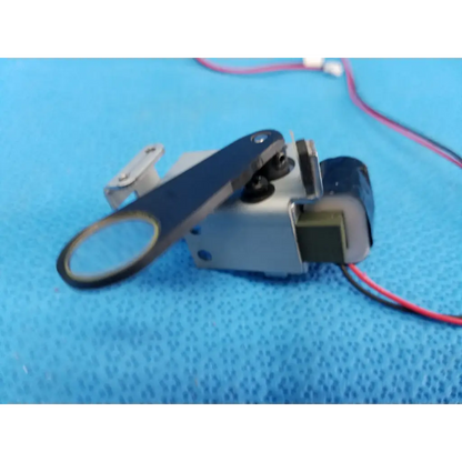 Black and silver mechanical rotary solenoid filter lever actuator with attached wires for Topcon TRC-NW8 fundus camera