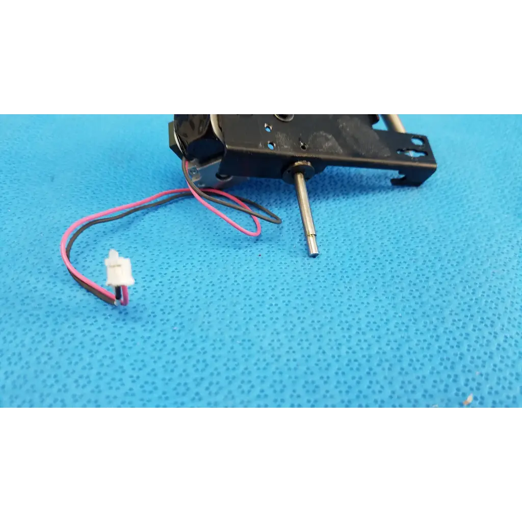Black plastic and metal rotary solenoid mechanical switch with pink and black wires for topcon fundus camera