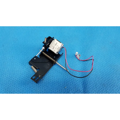 Black plastic and metal internal takano rotary solenoid mechanical switch with silver label and pink and black wires