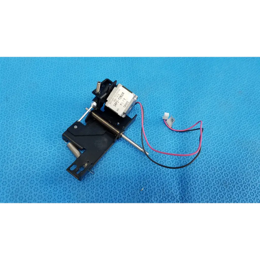 Black plastic and metal internal takano rotary solenoid mechanical switch with silver label and pink and black wires