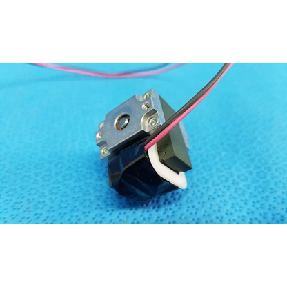 Black and silver internal Takano rotary solenoid with exposed wiring for Topcon TRC-NW8 fundus retinal camera