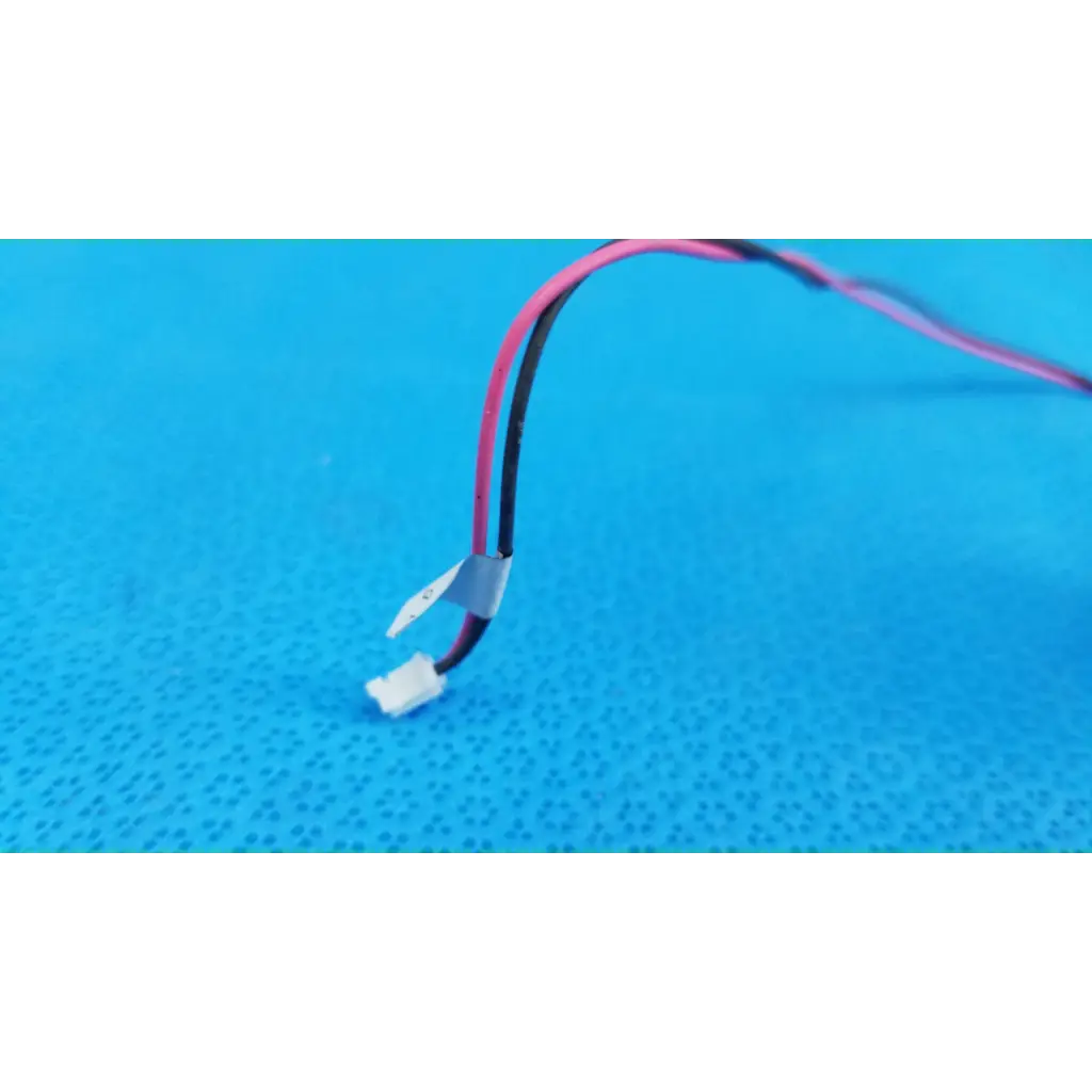 A pair of pink and black insulated wires with white connector and gray tape for internal rotary solenoid in fundus retinal camera