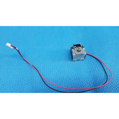 Silver rotary solenoid switch with pink and black wires connected to white connector for fundus retinal camera