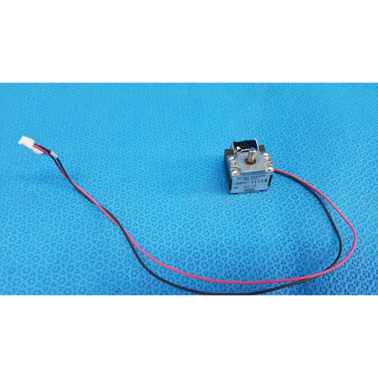 Silver rotary solenoid switch with pink and black wires connected to white connector for fundus retinal camera